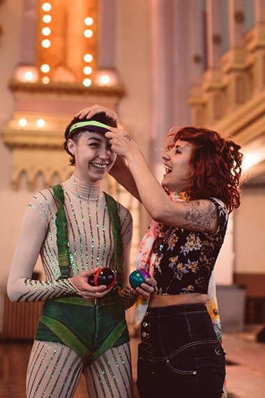 A social worker helps to try on a costume