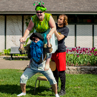 A participant stands on the shoulders of another participant